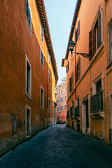 A narrow ancient alley with cobblestone in the historic center of Rome