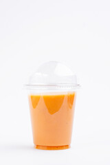 Orange juice in transparent plastic glass. Take away. Healthy food concept. High quality photo