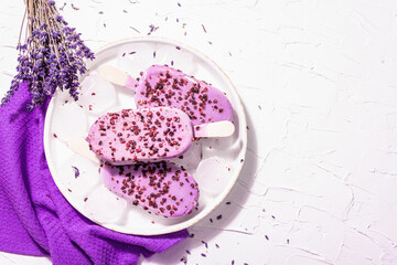 Purple Lavender flavored ice cream with flower bouquet, vintage silver spoon, ceramic stand