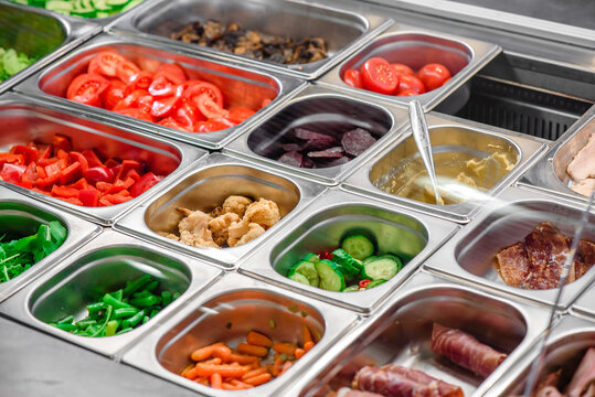 Showcase salad bar with an assortment of ingredients for healthy and dietary food. Salad take away. High quality photo