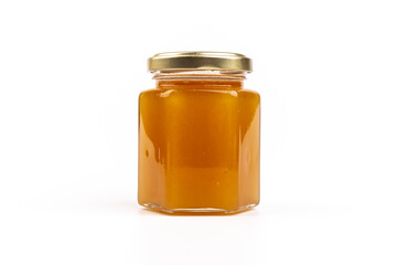 Glass jar full of sweet honey isolated on white background