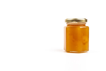 Glass jar full of sweet honey isolated on white background