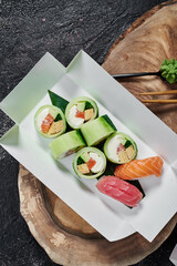 Sushi roll without rice in white paper box. Delivery service concept. Japanese food in eco-container. Top view. Waste-free packaging. High quality photo