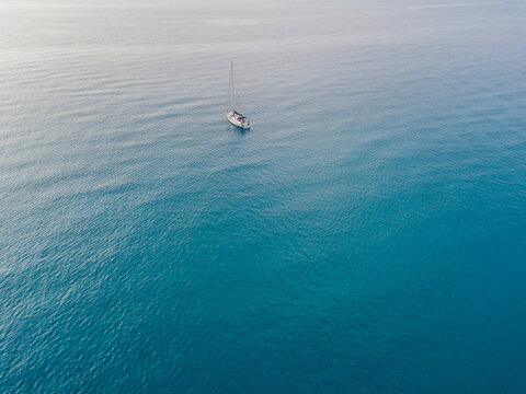 Aerial view of a sailboat moored off the coast of Calabria in Tropea. Italy. Tyrrhenian Sea. Coastline and blue sea © Naeblys