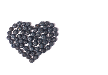 Blueberries laid out in the form of a heart isolated on white background