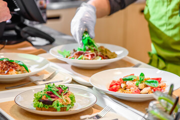 Chef prepares salad at the salad bar. Salad making process. High quality photo