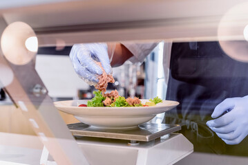 Showcase salad bar with an assortment of ingredients for healthy and dietary food. Salad making process. High quality photo