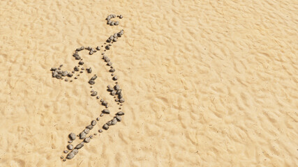 Concept conceptual stones on beach sand handmade symbol shape, golden sandy background, volleyball player sign. 3d illustration metaphor for sport, competition training,  relaxation, family and fun