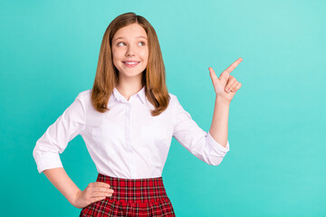 Portrait of attractive cheerful girl showing copy empty blank space isolated over bright teal...