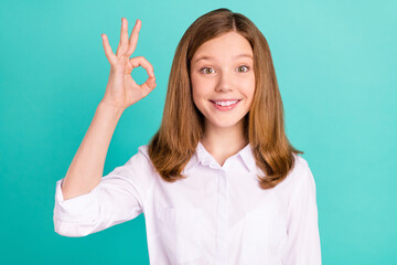 Portrait of attractive cheerful girl showing ok-sign agree ad perfect isolated over vibrant teal turquoise color background