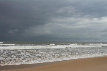 Fototapeta na wymiar Shocking and beautiful storm clouds on the sea coast. Dark colored clouds in the sky.