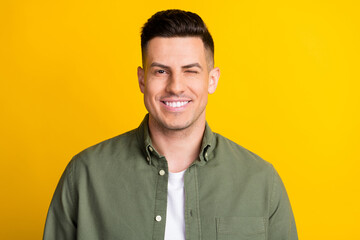 Photo portrait man wearing shirt smiling winking isolated bright yellow color background