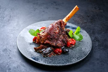 Badezimmer Foto Rückwand Modern style traditional braised slow cooked lamb shank in red wine sauce with eggplants and tomatoes served as close-up in a design plate © HLPhoto