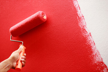 Painter is painting the interior wall red