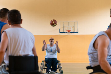 disabled war veterans in action while playing basketball on a basketball court with professional...