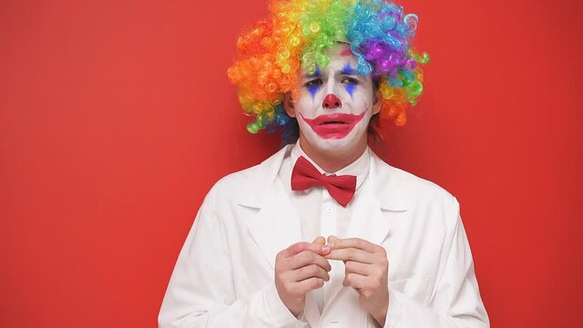 Portrait of a sad clown with a painted face on an isolated background