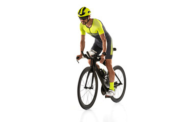 Studio shot of one young professional bicyclist, man on road bike isolated over white background.