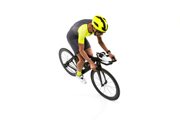 View from above. One young professional bicyclist in sportswear, man riding on road bike isolated...