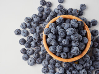 Blueberry fruit top view isolated on a white background, flat lay overhead layout with mint leaf, healthy design concept.