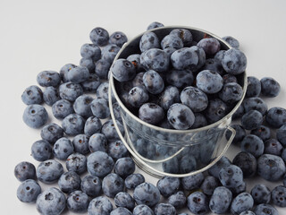 Blueberry fruit top view isolated on a white background, flat lay overhead layout with mint leaf, healthy design concept.
