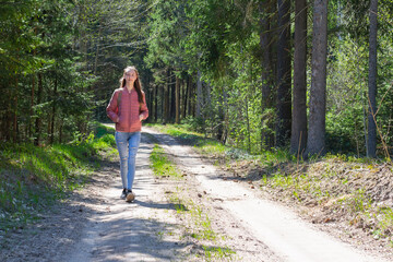 Lonely one girl walk in the road forest summer spring background, Relax time on holiday concept travel.