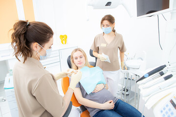 pregnant woman at the dentist's office, checkup and dental treatment for pregnant women.