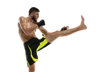 Professional male MMA boxer in motion isolated on white studio background. Fit muscular caucasian athlete fighting.