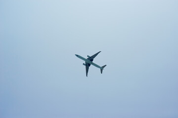 Fototapeta na wymiar Black silhouette of a passenger plane in the blue sky