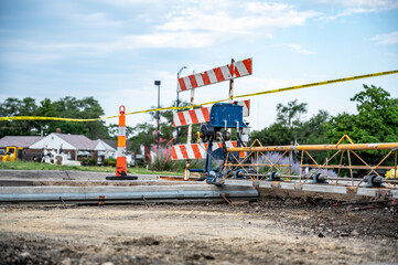 Power screed setup and ready for pouring concrete on prepared subbase of a road repair