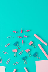 Creative business concept made of  colorful paper clips, chalks, pencil, papers. Blue background. Flat lay.