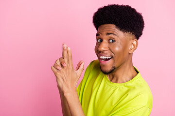 Profile side photo of young black guy happy positive smile show fingers gun sign isolated over pink color background