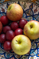 plum, cherry, apple, fruits on color plate