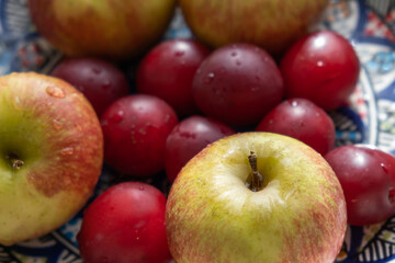 plum, cherry, apple, fruits on color plate