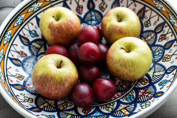 plum, cherry, apple, fruits on color plate