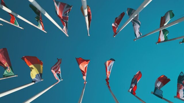 Different flags fluttering on flagpoles