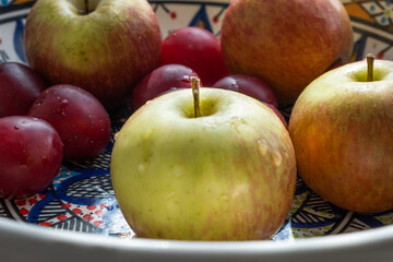 plum, cherry, apple, fruits on color plate