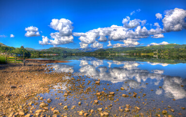 Beautiful lake with clear water and mountains on a calm still summer day in Ullswater the Lake District England in colourful HDR