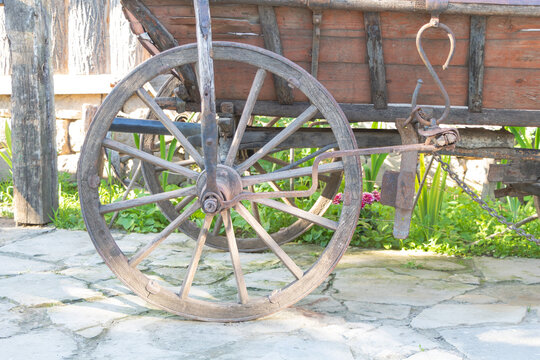 Wooden wheel of a horse drawn cart close up
