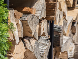 Stacked firewood for kindling the stove or fireplace. Wooden background.