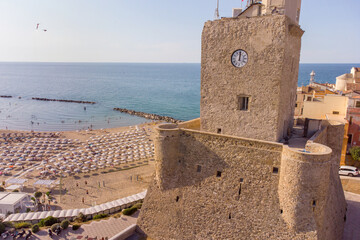 Panoramic aerial view of the beach and the ancient Castello Svevo fortress during a summer day , in the ancient town of Termoli , Molise , Italy - obrazy, fototapety, plakaty