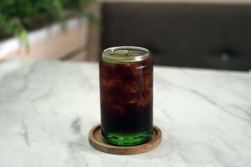 A glass of tea with kiwi syrup