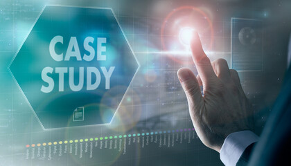 A businessman controlling a futuristic display with a Case Study business concept on it.