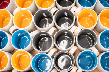 close up of colorful ceramic mug on shelf