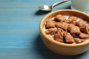 Tasty corn pads with milk served on turquoise wooden table, closeup. Space for text