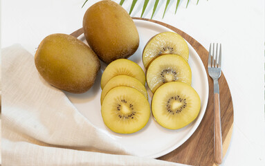 gold kiwi on white plate
