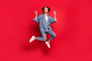 Fototapeta na wymiar Full size photo of young woman happy positive smile show peace cool v-sign jump isolated over red color background