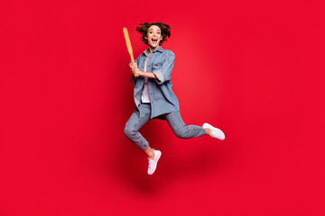 Fototapeta na wymiar Full size photo of young woman excited play baseball sporty hit game isolated over red color background