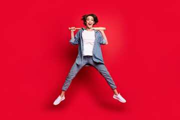 Fototapeta na wymiar Full length photo of young woman happy positive smile hold baseball bat player isolated over red color background