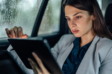 Adult woman, checking the news, on her tablet.