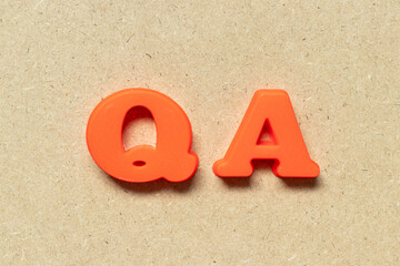 Plastic alphabet letter in word QA (abbreviation of quality assurance or question and answer) on...